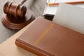 Judge`s gavel, book and documents on wooden table