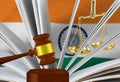 The judge\'s gavel, the book of laws and scales against the background of the flag of Republic of India.3d-image