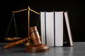 Judge`s gavel, books and scales on grey table against background. Criminal law concept Royalty Free Stock Photo