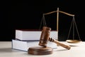 Judge`s gavel, books and scales on white wooden table. Criminal law concept