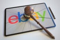 Judge's gavel and broken tablet computer screen with logo of EBAY. Editorial conceptual 3d rendering