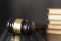 Judge`s gavel on computer keyboard with copy space with law books on the background Royalty Free Stock Photo