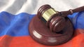 Judge`s gavel on the flag of Russia