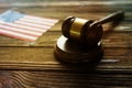Judge`s gavel, flag of the United States of America against the background of a wooden table. Royalty Free Stock Photo