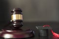 Judge`s gavel and graduation cap on black wooden table Royalty Free Stock Photo