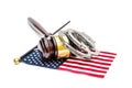 Judge`s gavel with handcuffs and american flag on white. American laws concept