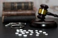 Judge`s gavel with handcuffs, drugs on wooden table