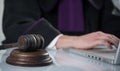 Judge`s gavel. Modern white desk with an open laptop. White background. Royalty Free Stock Photo