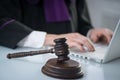 Judge`s gavel. Modern white desk with an open laptop. White background. Royalty Free Stock Photo