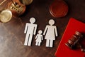 Judge's gavel on a red book and family figures. Family law Royalty Free Stock Photo