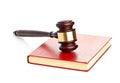 Judge's gavel on red legal book