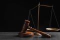 Judge`s gavel and scales on grey table against background. Criminal law concept Royalty Free Stock Photo