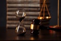 Judge`s gavel, scales of justice, books and hourglass on wooden table. Law concept Royalty Free Stock Photo