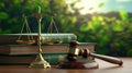 A judge's gavel sits on top of a stack of books and a gold scale Royalty Free Stock Photo