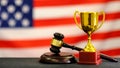 Judge`s gavel and trophy USA flag. Symbol for jurisdiction. Law concept a wooden judges gavel on table in a courtroom or Royalty Free Stock Photo