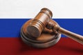 Judge`s gavel on wooden background in color of Russian flag. Concept of sanctions against Russia Royalty Free Stock Photo