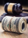 Judge`s hammer gavel. Justice dollars banknotes and usa flag in the background. Court gavel and rolled banknotes. Royalty Free Stock Photo