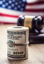 Judge`s hammer gavel. Justice dollars banknotes and usa flag in the background. Court gavel and rolled banknotes. Royalty Free Stock Photo