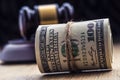 Judge`s hammer gavel. Justice dollars banknotes and usa flag in the background. Court gavel and rolled banknotes. Royalty Free Stock Photo