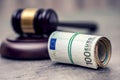 Judge's hammer gavel. Justice and euro money. Euro currency. Court gavel and rolled Euro banknotes.