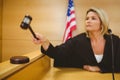 Judge about to bang gavel on sounding block Royalty Free Stock Photo