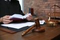 Judge working at table in office, focus on gavel Royalty Free Stock Photo