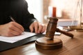 Judge working at table in office, focus on gavel Royalty Free Stock Photo
