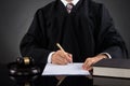 Judge Writing On Paper In Courtroom Royalty Free Stock Photo
