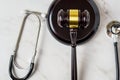 A judge's gavel and a physician's stethoscope. access and entitlement to health care regardless of race, religion