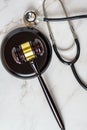 A judge's gavel and a physician's stethoscope. access and entitlement to health care regardless of race, religion