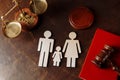 Judge's gavel on a red book and family figures Royalty Free Stock Photo