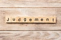 Judgement word written on wood block. judgement text on table, concept Royalty Free Stock Photo
