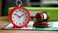 Judges gavel with alarm clock on financial documents