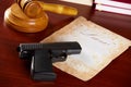 Judges gavel with gun and very old paper Royalty Free Stock Photo