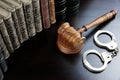 Judges Gavel, Handcuffs And Old Book On The Black Table