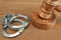 Judges Gavel And Handcuffs On Wood Rough Background Royalty Free Stock Photo