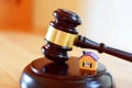 Judges gavel on sound block next to yellow colorful house Royalty Free Stock Photo