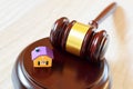 Judges gavel on sound block next to yellow colorful house Royalty Free Stock Photo