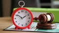 Judges hammer with red alarm clock on clipboard