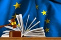 Judicial gavel on the background of an open book and the flag of the European Union Royalty Free Stock Photo