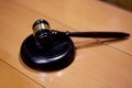 Judicial gavel HAMMER years on a backing on a wooden table, close-up, selective focus