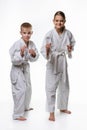 Judo boy and girl students in a rack, white background Royalty Free Stock Photo