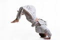 Judo boy in white kimono doing somersault Royalty Free Stock Photo