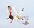 Judo throws are training boys in judogi Royalty Free Stock Photo