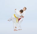 In judogi athletes are training throws on a light background Royalty Free Stock Photo