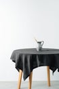 Jug with cereal ear on a round table with a black rough tablecloth Royalty Free Stock Photo