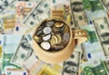 Jug with coins on a table with money