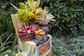 A jug of flowers, a jug of wheat ears, a basket of red apples, and a basket of peppers Royalty Free Stock Photo