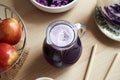 A jug of fresh purple cabbage juice on a table Royalty Free Stock Photo