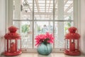 Jug of fresh summer flowers and lamps on a window sill